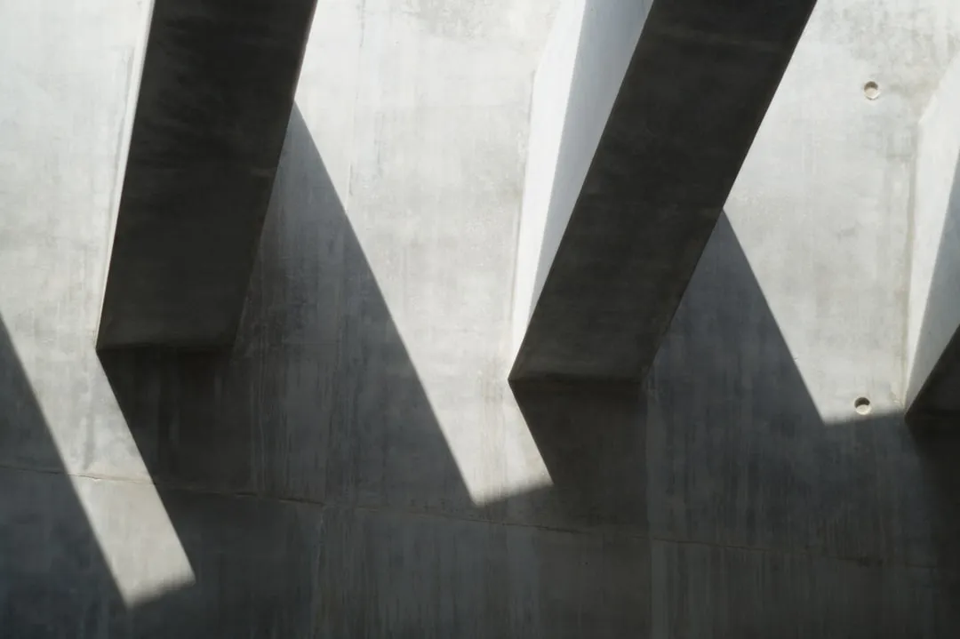 the shadow of a building on the side of it